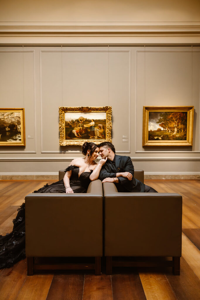 bride and groom sitting on the sofas in front of paintings during their elopement at the national gallery of art in washington dc
