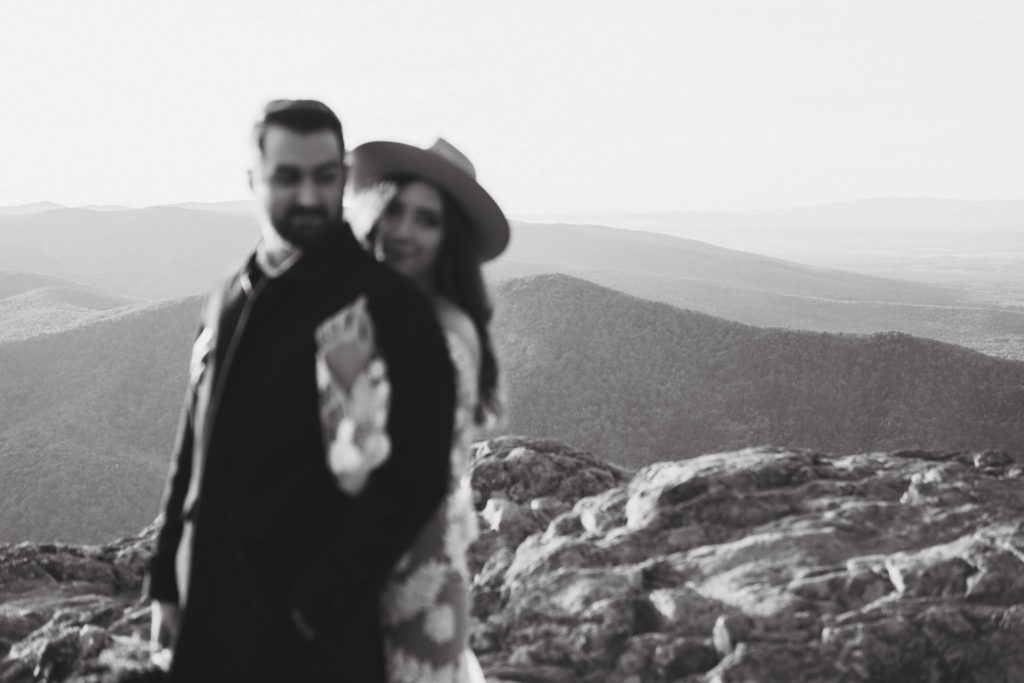 Black and white photo focused on the mountains behind a wedding couple during their Raven's Roost Overlook Elopement in the Virginia Mountains. 