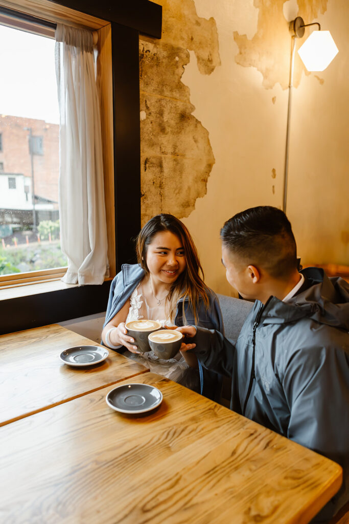 bride and groom enjoying lattes at a coffee shop 