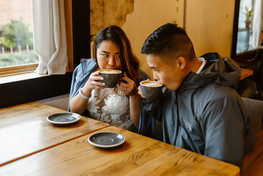 bride and groom enjoying lattes at a coffee shop 
