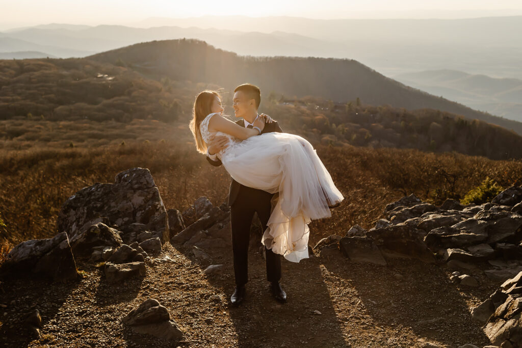 playful elopement couple on a mountain overlook during sunset for their golden hour moments in Shenandoah National Park