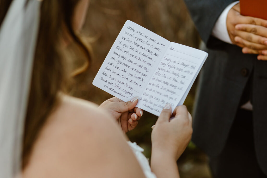 close up of bride holding vow book