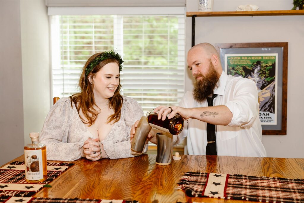bride and groom drinking mead from viking inspired cups