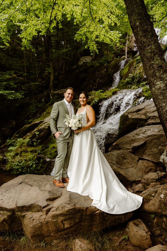 bride and groom at a waterfall during their shenandoah national park elopement