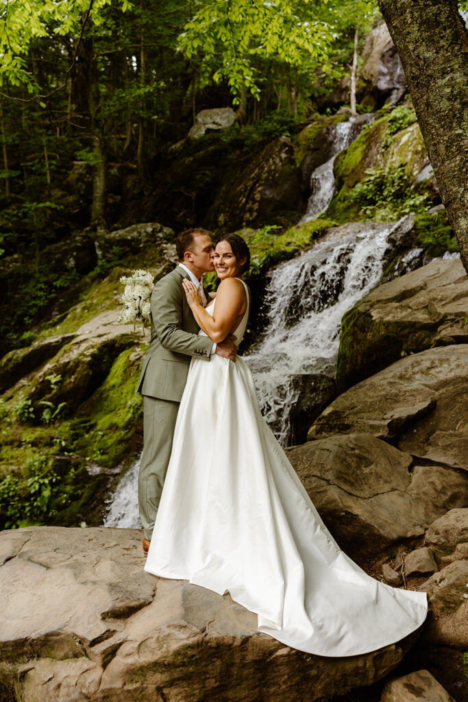 bride and groom at a waterfall during their shenandoah national park elopement