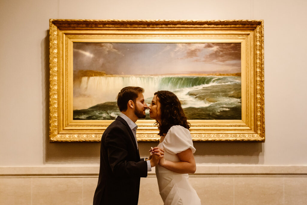The engaged couple in front of art at the National Gallery of Art