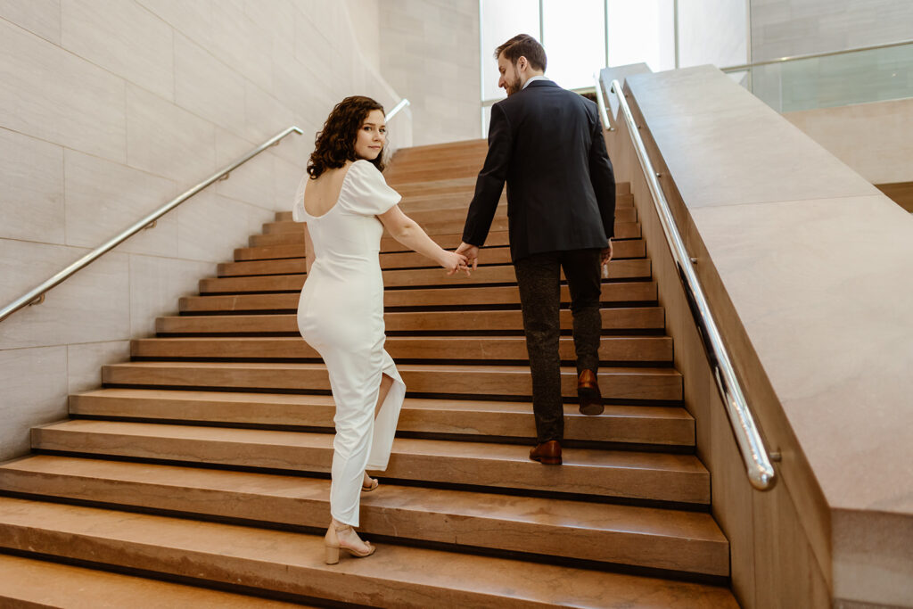 the engaged couple walking up the staircase together during DC engagement photos
