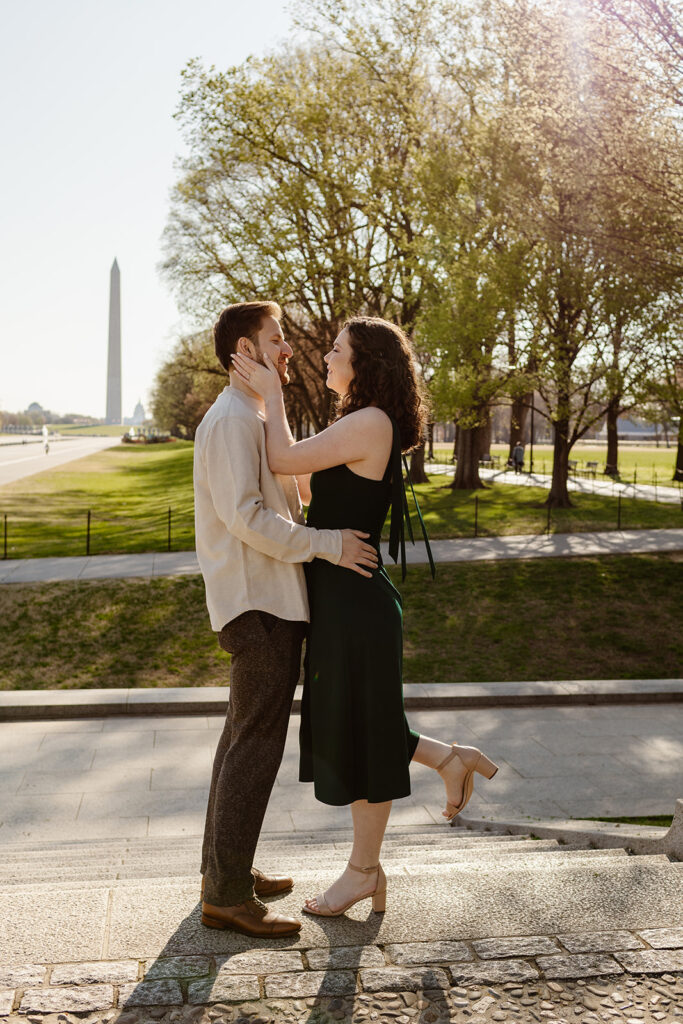 the couple hugging in front of the Washington Monument during their spring engagement photos