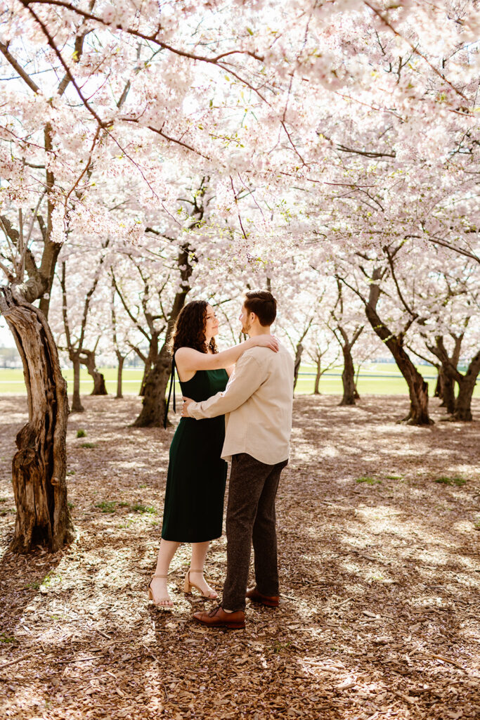 The engaged couple slow dancing in the cherry blossoms in Washington DC
