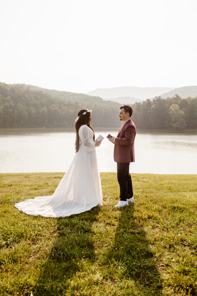 couple standing outside together for their outdoor elopement ceremony near a lake