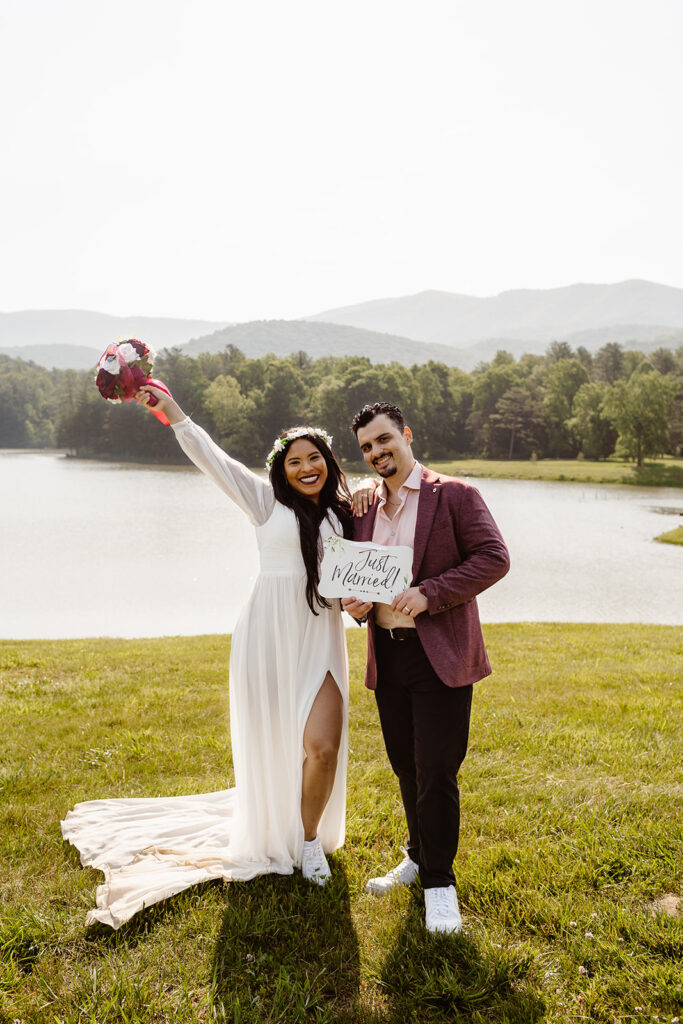 the wedding couple posing with a just married sign for creative elopement photos