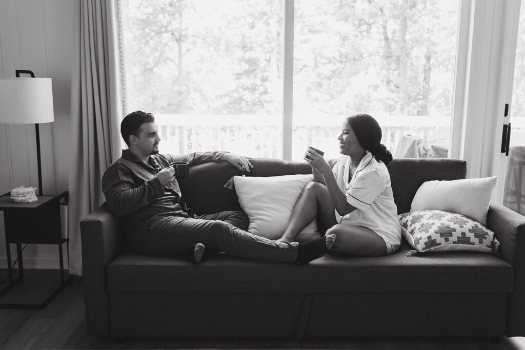 bride and groom sitting on the sofa enjoying a cup of tea