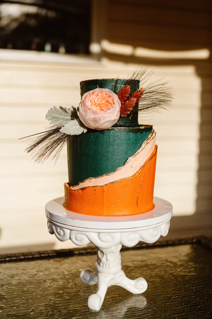 artistic wedding cake with orange and green for a fall elopement
