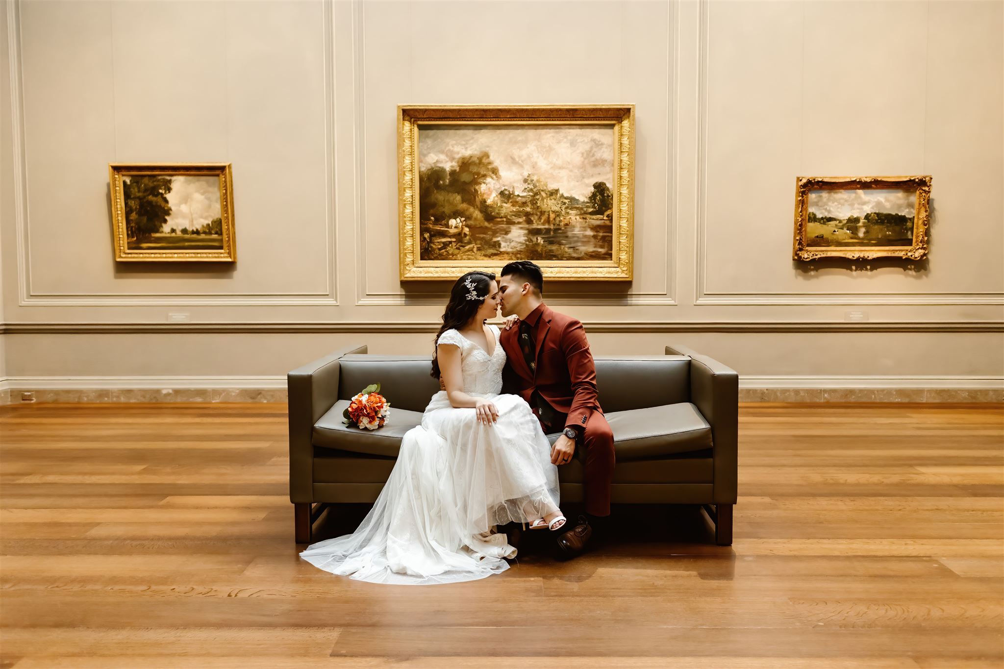 the bride and groom sitting on the couch at the National Gallery of Art