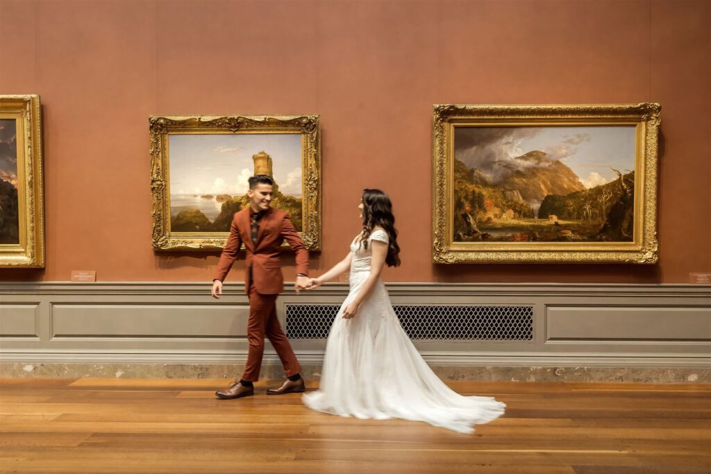 the wedding couple walking through the National Gallery of Art