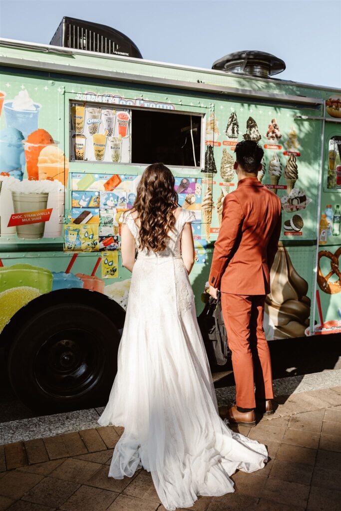 the wedding couple ordering ice cream at the ice cream truck