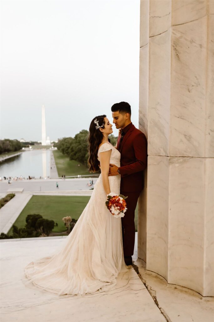 the bride and groom with the Washington Monument in the background
