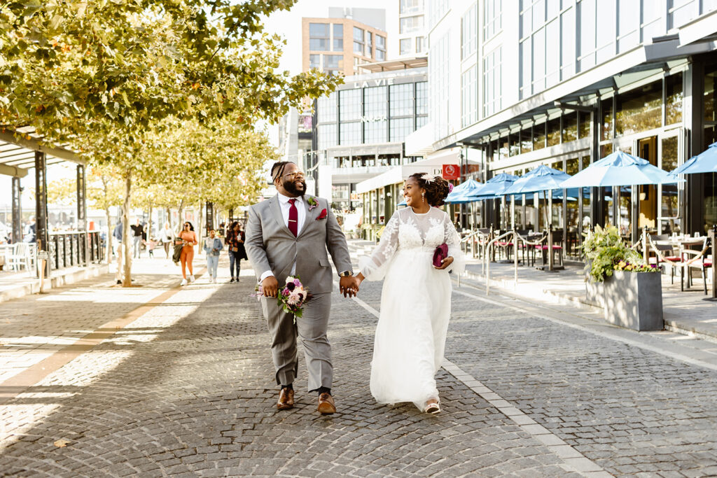 wedding couple holding hands as they walk through DC for their elopement 
