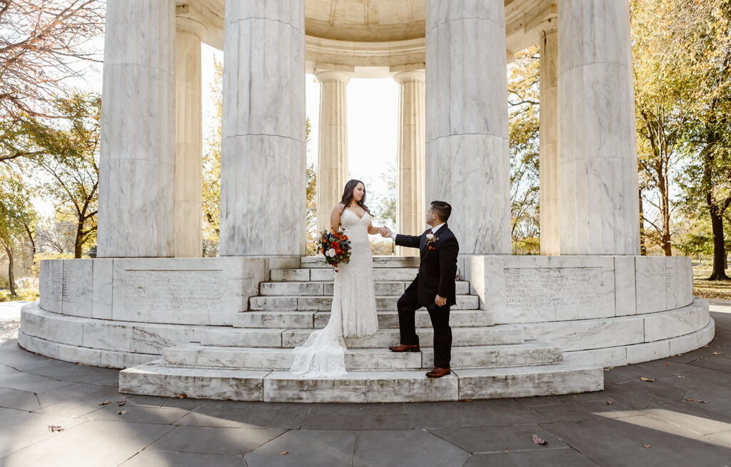 the wedding couple posing on the steps of the dc war memorial for their dc elopement