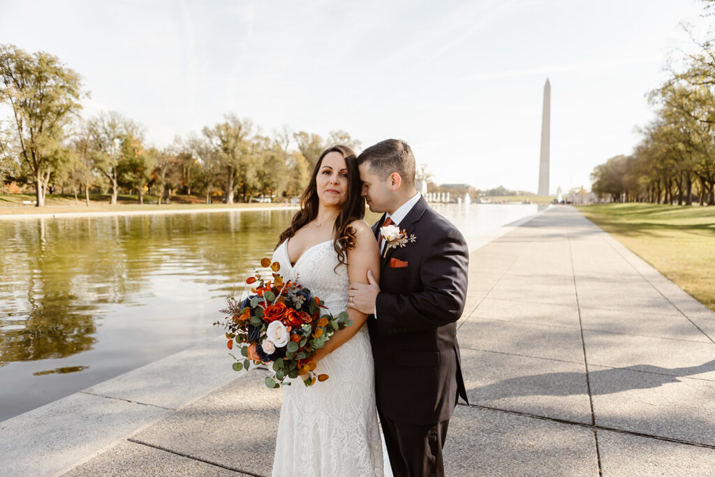 the wedding couple visiting the Washington monument after their dc war memorial wedding