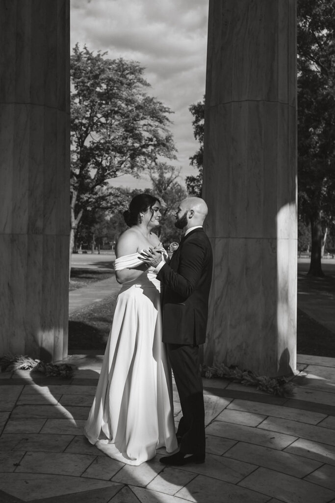 black and white wedding photo of the wedding couple dancing at the dc war memorial