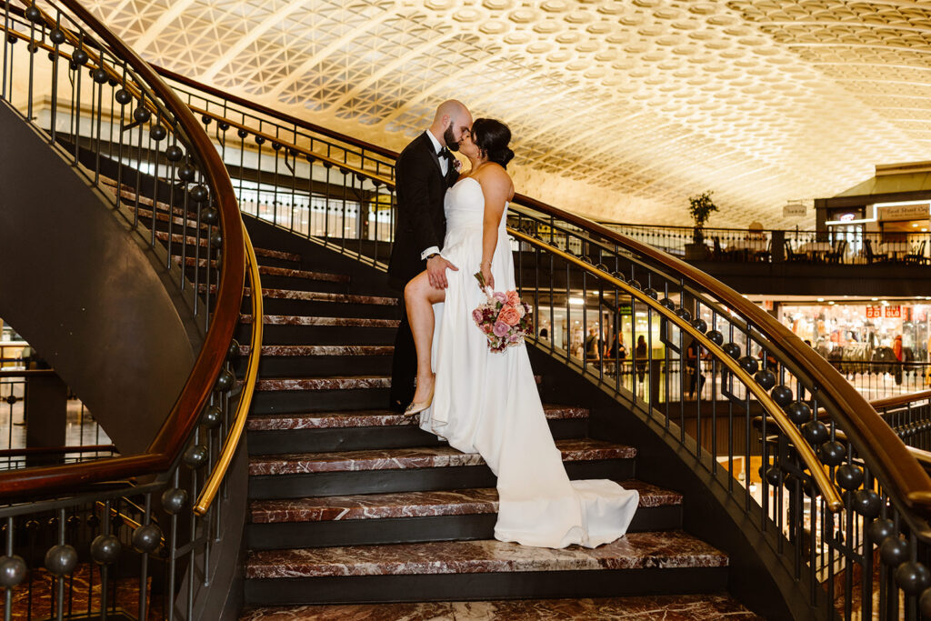 the wedding couple on a staircase for luxury wedding photography of the dc elopement