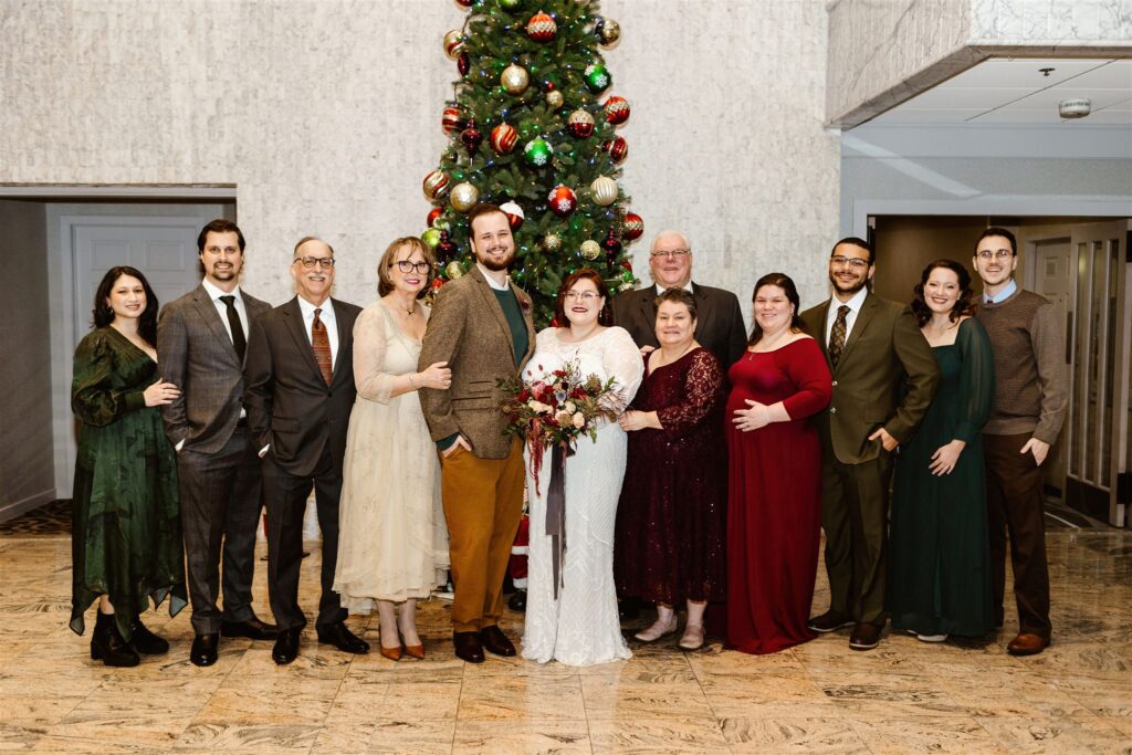 wedding family photos of the winter wedding in front of the christmas tree