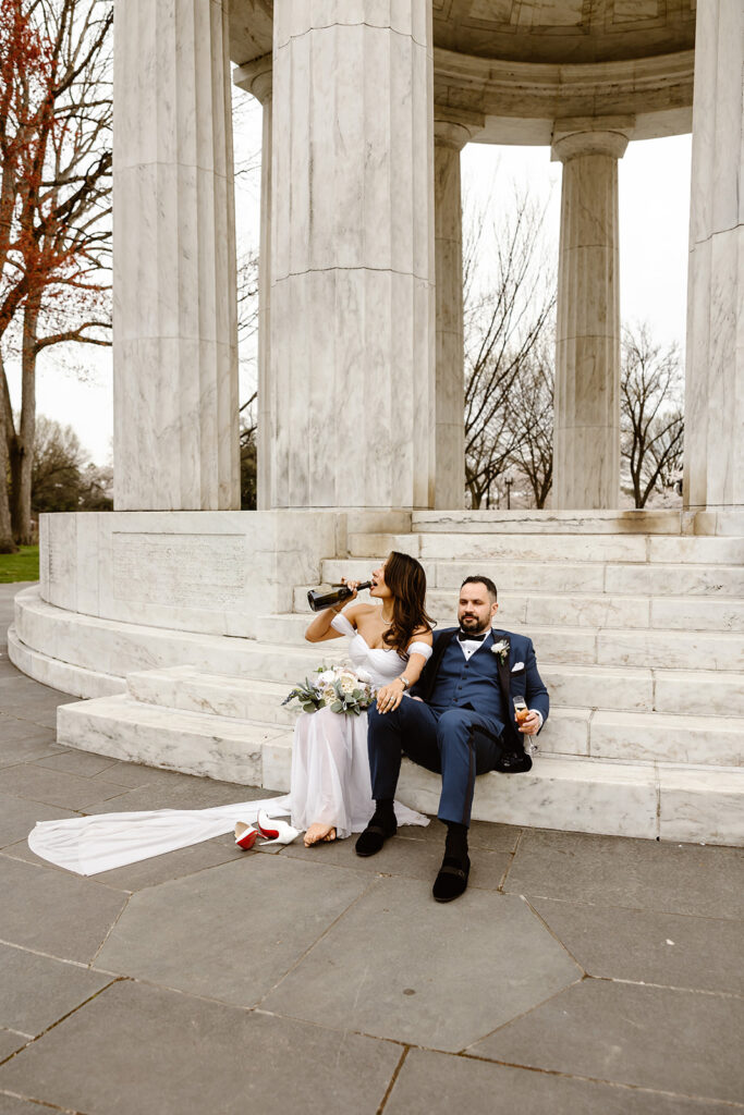 the wedding couple sitting on the steps outside of the war memorial