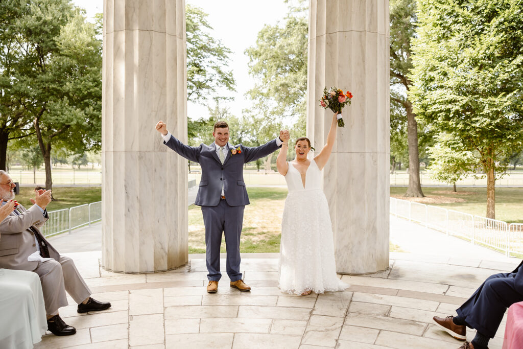 the wedding couple celebrating together at the dc war memorial