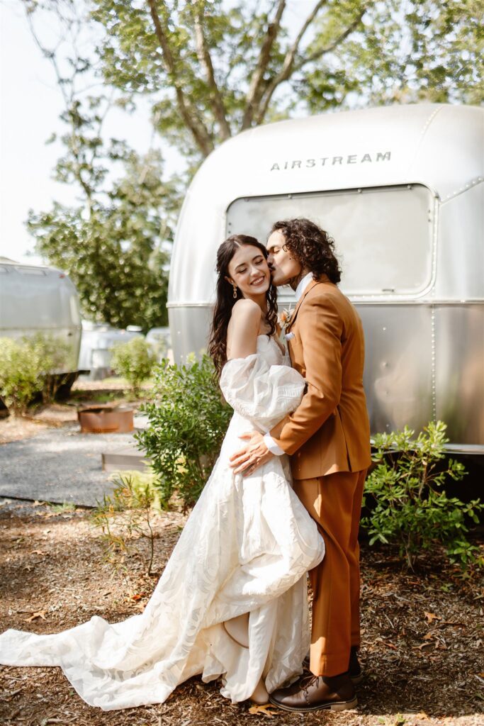 the wedding couple posing outside of their airstream for their elopement