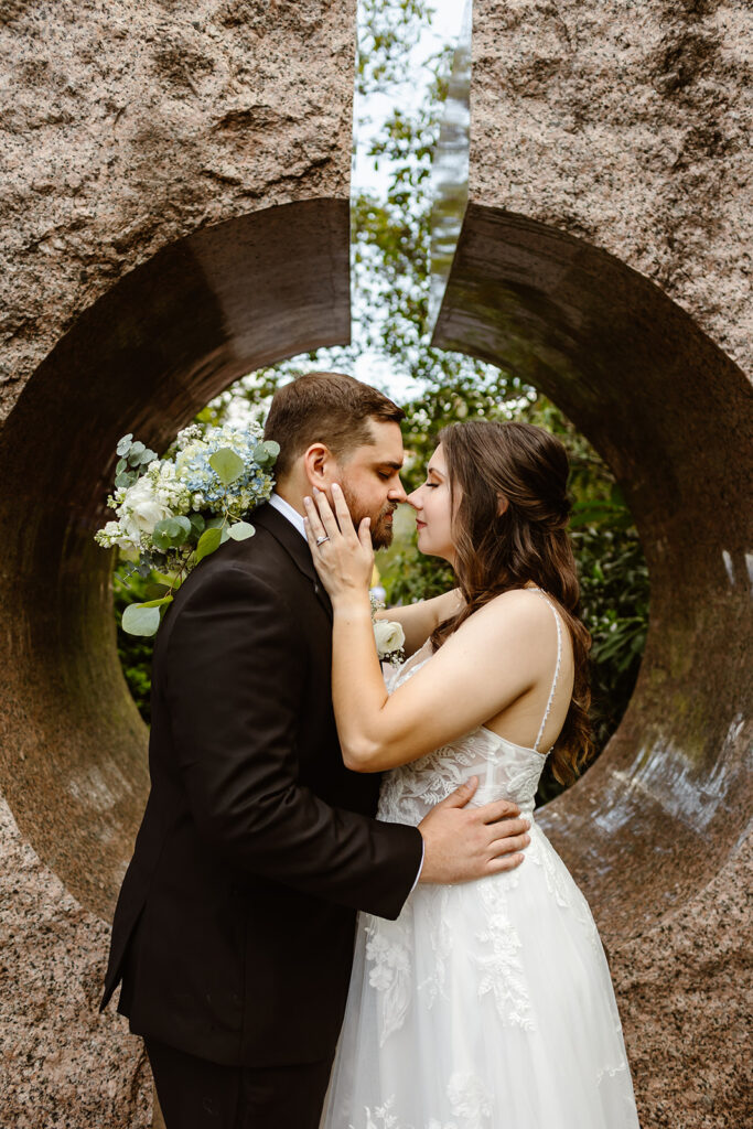 the engaged couple leaning into kiss at the Smithsonian Castle gardens in Washington DC