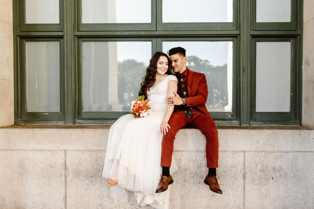 the wedding couple sitting outside of Union Station