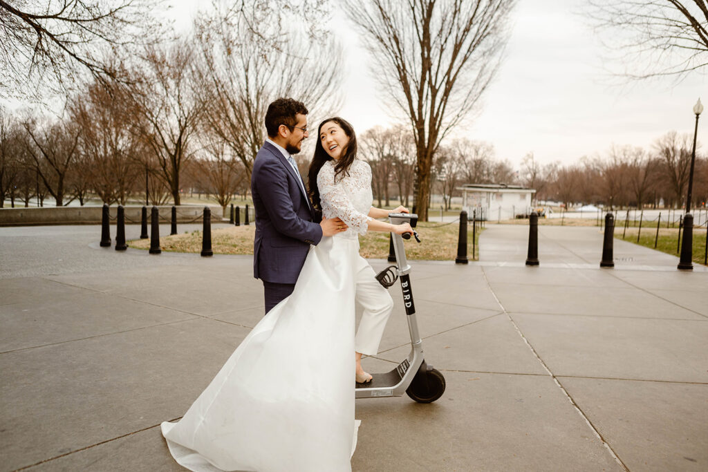 wedding couple riding on a scooter during their DC elopement