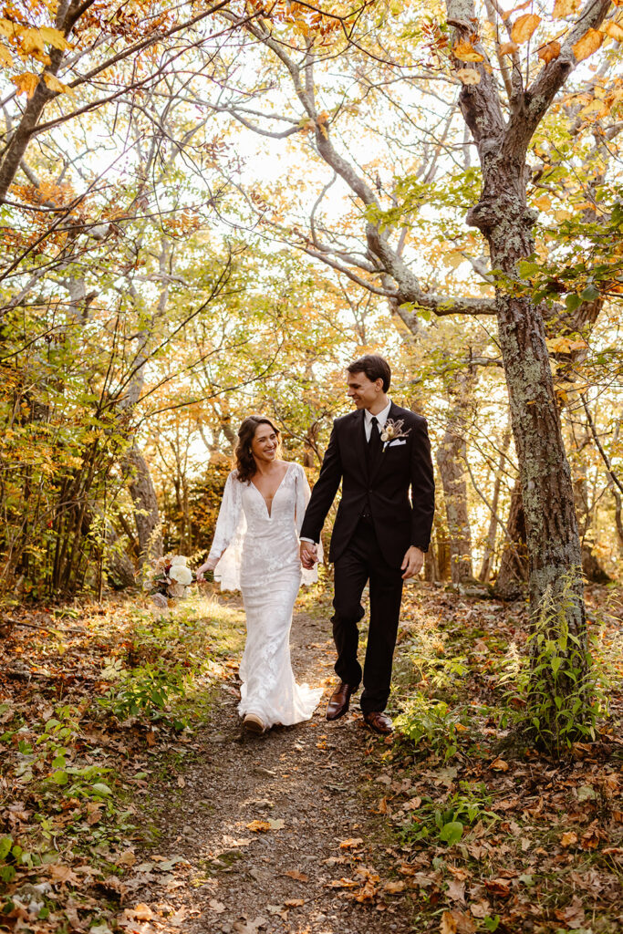 the wedding couple walking together as they hike up the mountain for the Shenandoah National Park elopement