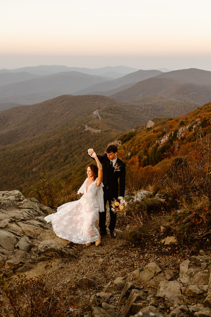 the wedding couple dancing on the mountains during their adventure elopement in Virginia