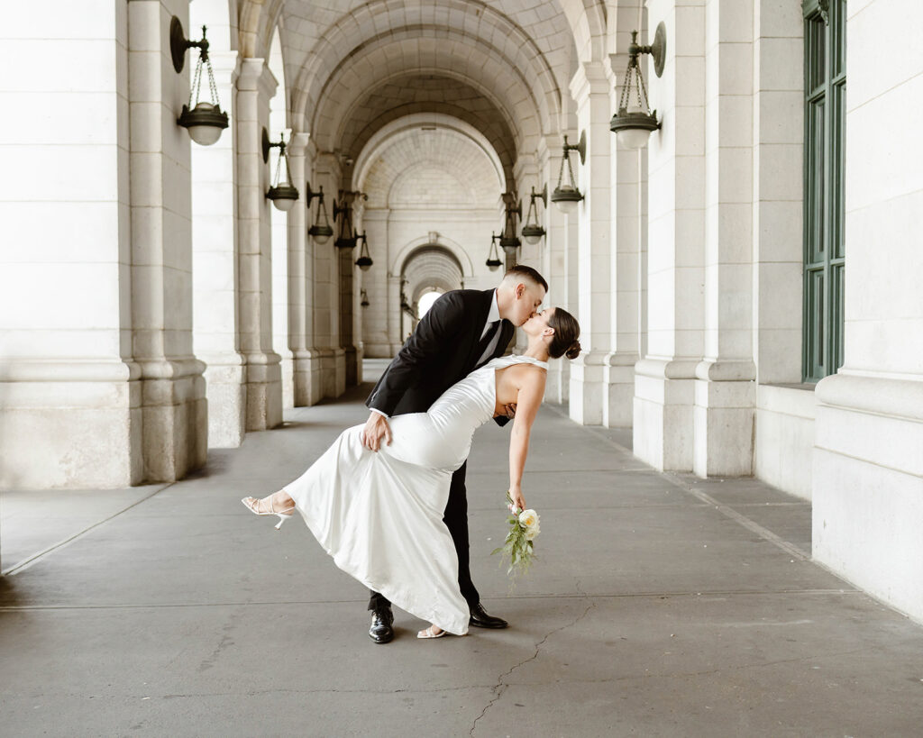 bride and groom dip kiss during their dc elopement at the union station