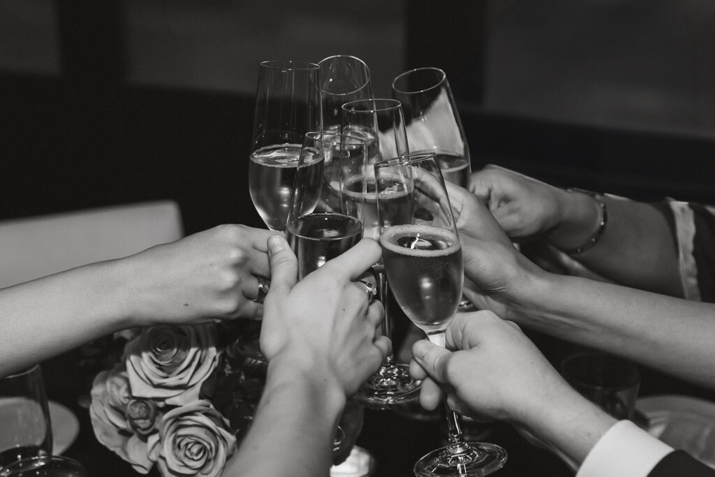 champagne glasses clinking together to celebration the wedding couple at the DC elopement