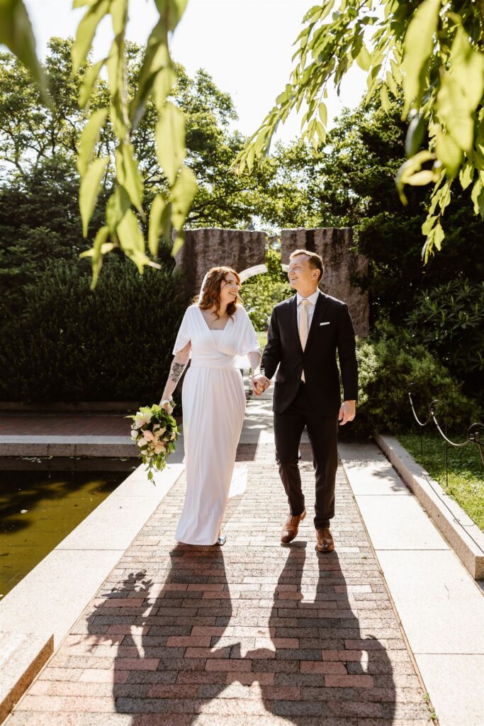 bride and groom exploring enid a haupt garden at the smithsonian castle
