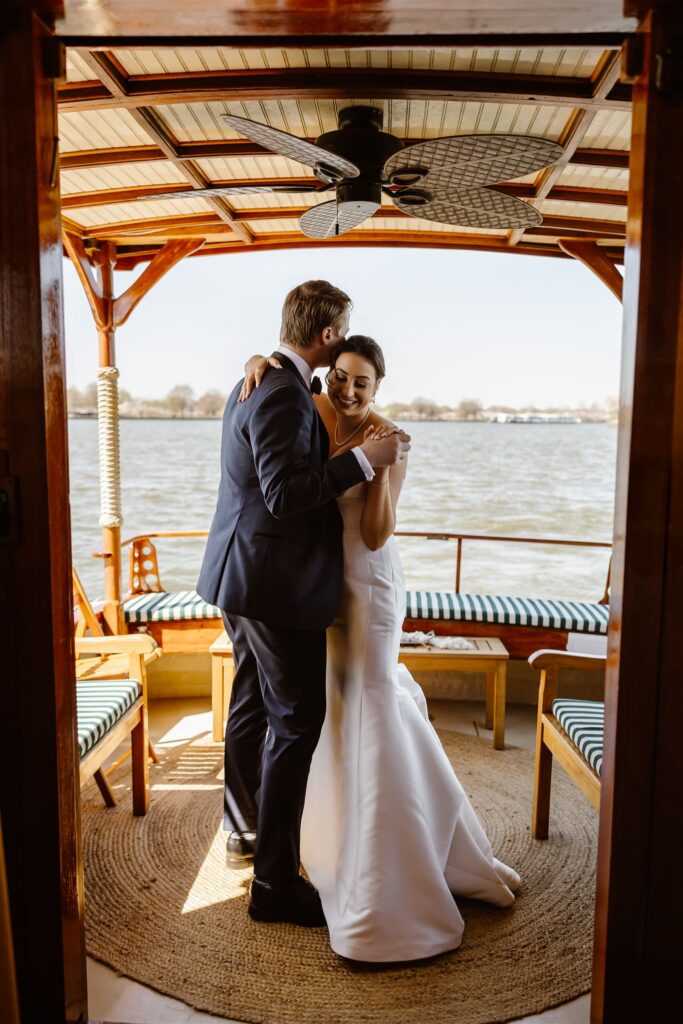 bride and groom sharing a first dance on a yacht over the potomac