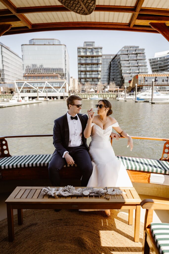 bride and groom enjoying a luxurious yacht ride over the potomac during their washington dc elopement
