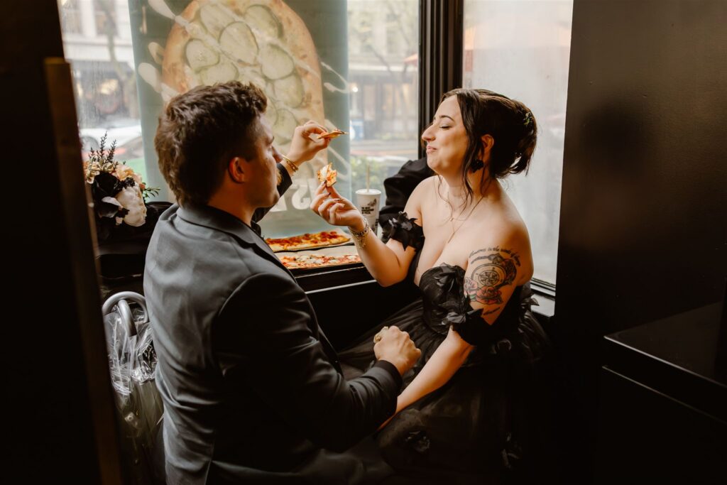 bride and groom sharing a pizza together