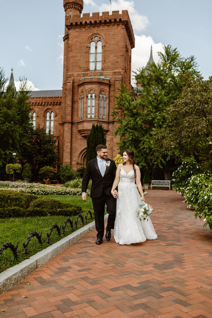 the wedding couple walking through the Smithsonian Castle for their DC elopement