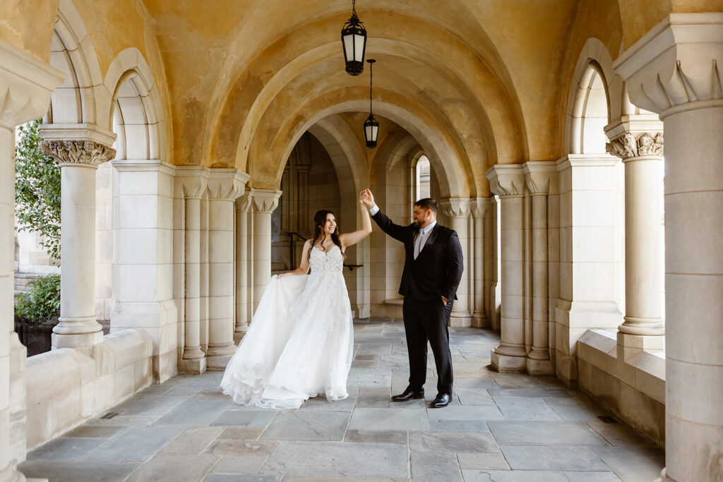the elopement couple twirling at the National Cathedral for elopement photos