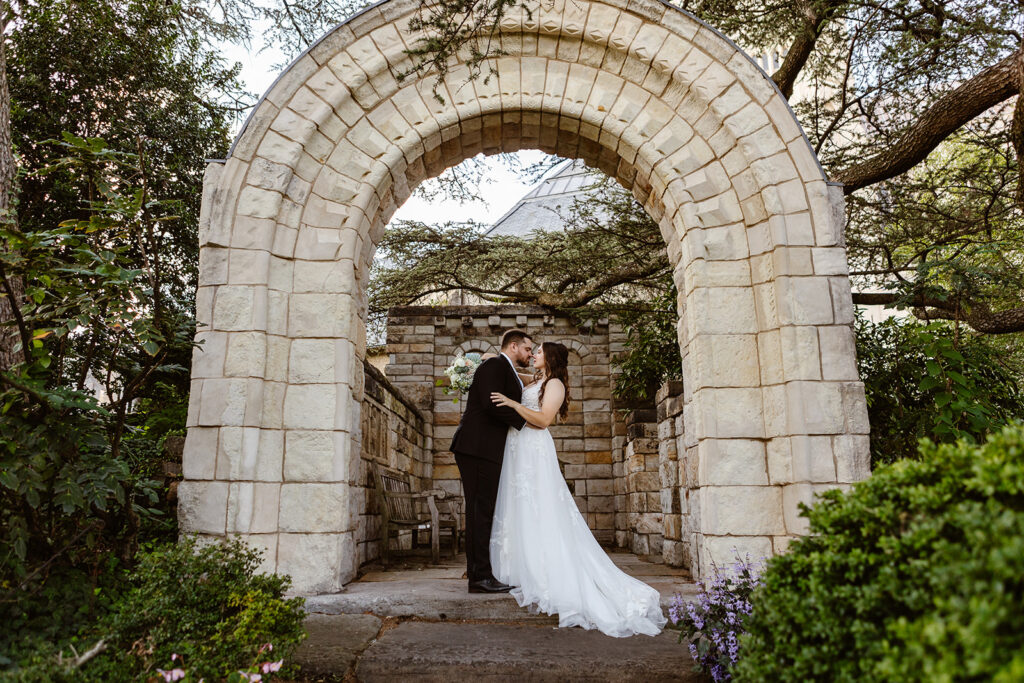 the elopement couple kissing in the gardens of the National Cathedral