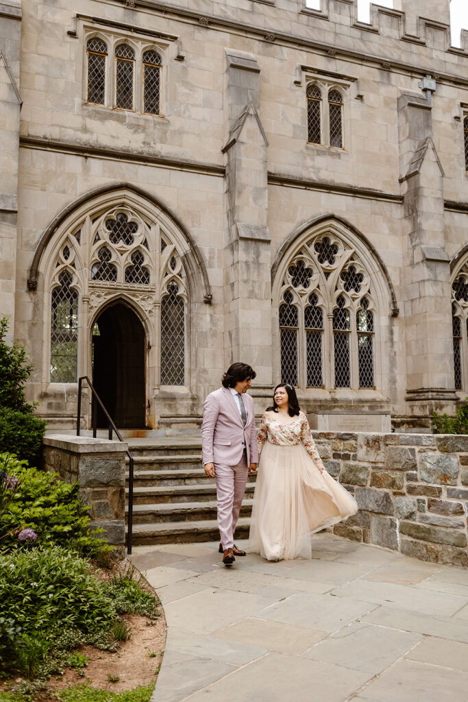 the elopement couple walking down the stairs of the National Cathedral