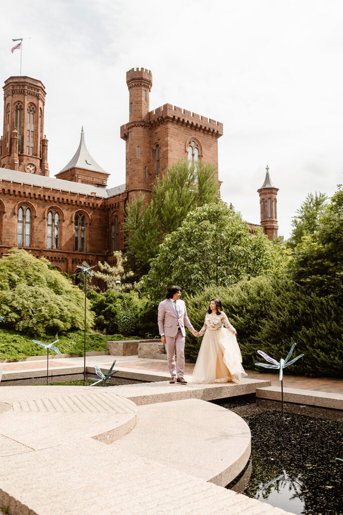 elopement couple walking through the courtyard of the Smithsonian Castle