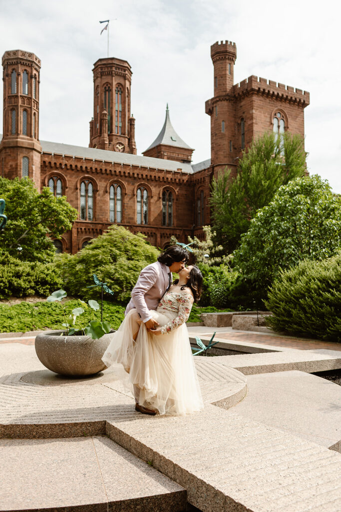 the DC elopement couple kissing at the Smithsonian Castle
