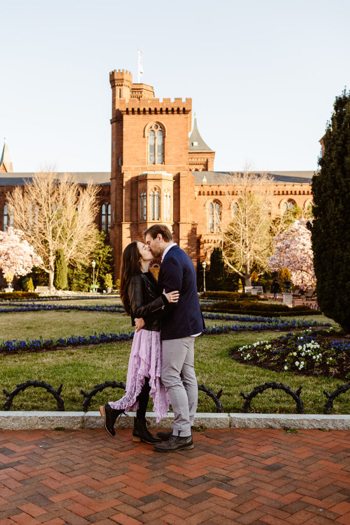 Couple kissing in the courtyard of the Smithsonian Castle