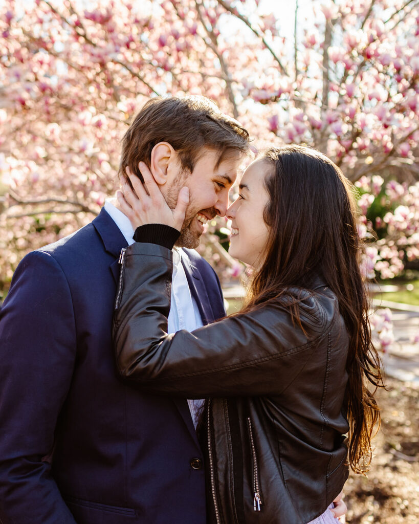 the couple smiling at one another before kissing at the Smithsonian Castle