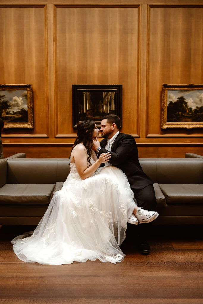 the elopement couple sitting on the couch in the National Gallery of Art